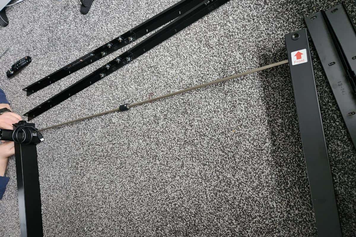 metal pieces of a standing desk during assembly.