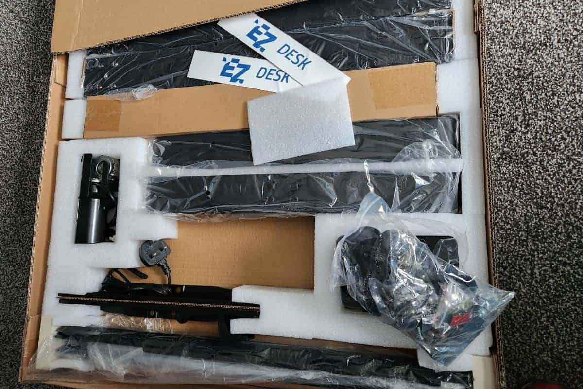 The packaging and parts for a standing desk.