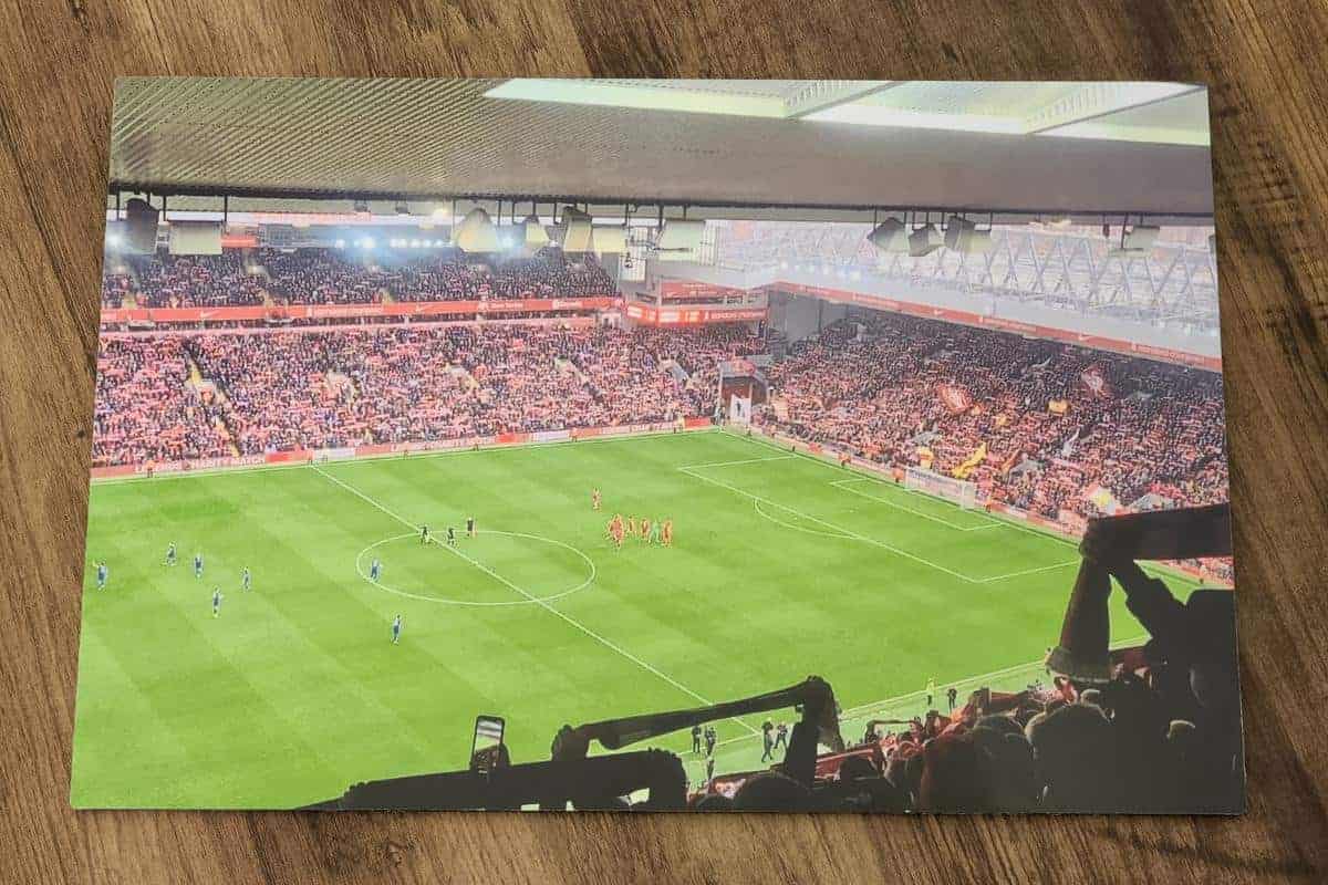 Aluminium print of a football ground with players on the pitch and take by one of the spectators with many supporters waving scarfs and cheering.