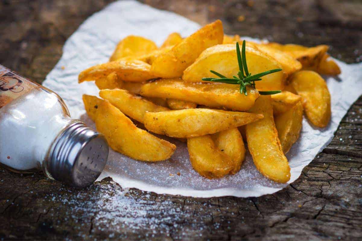 potato wedges topped with a sprig of rosemary.