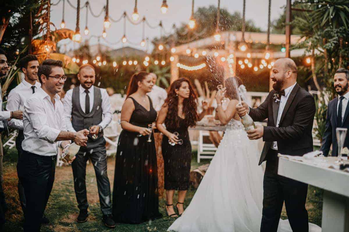 group of people celebrating a wedding outside