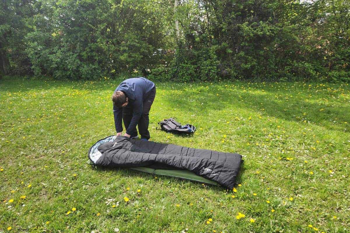 young man setting up a camp