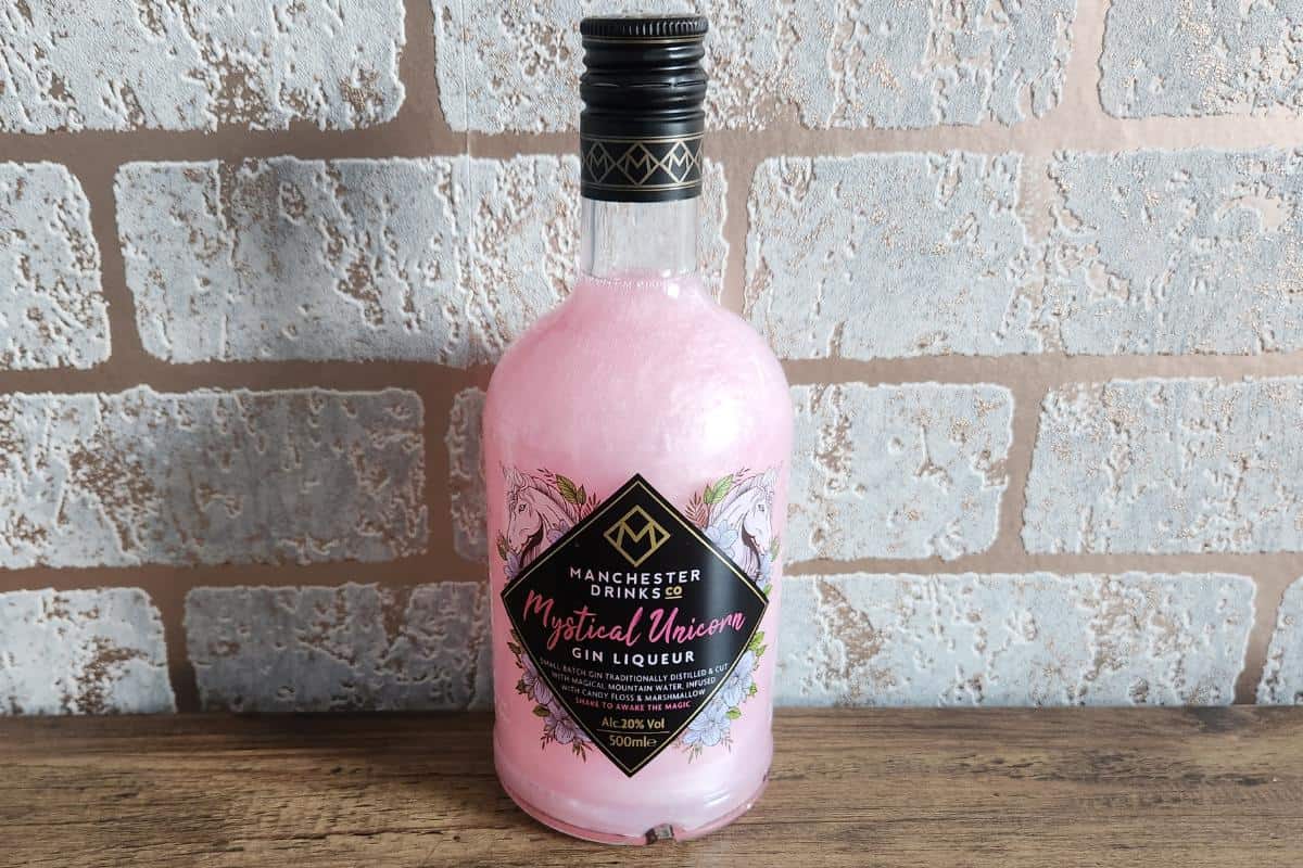 gin liqueur bottle with a pink shimmering liquid inside.