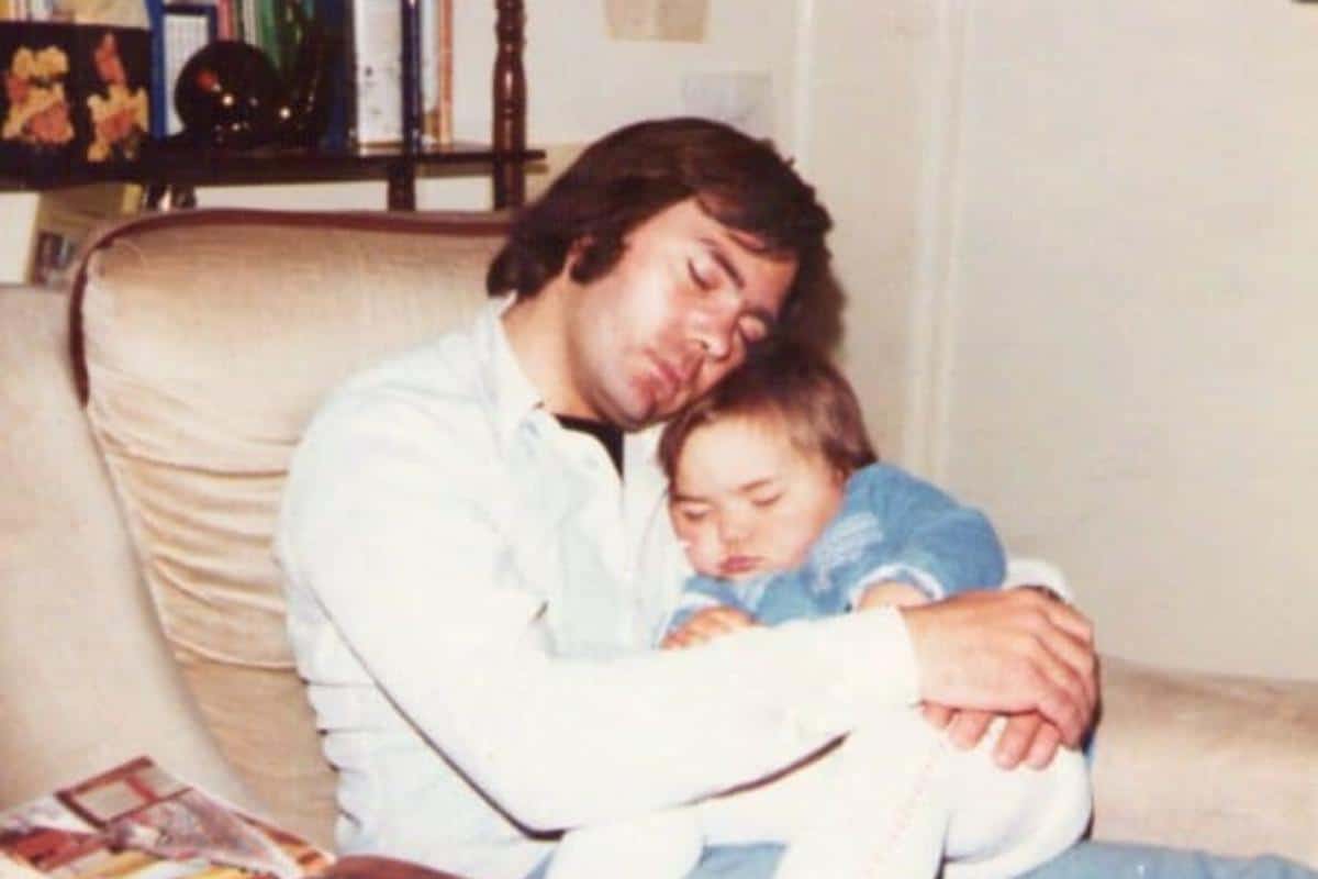 girl toddler asleep on her dad cuddled up, he is asleep too
