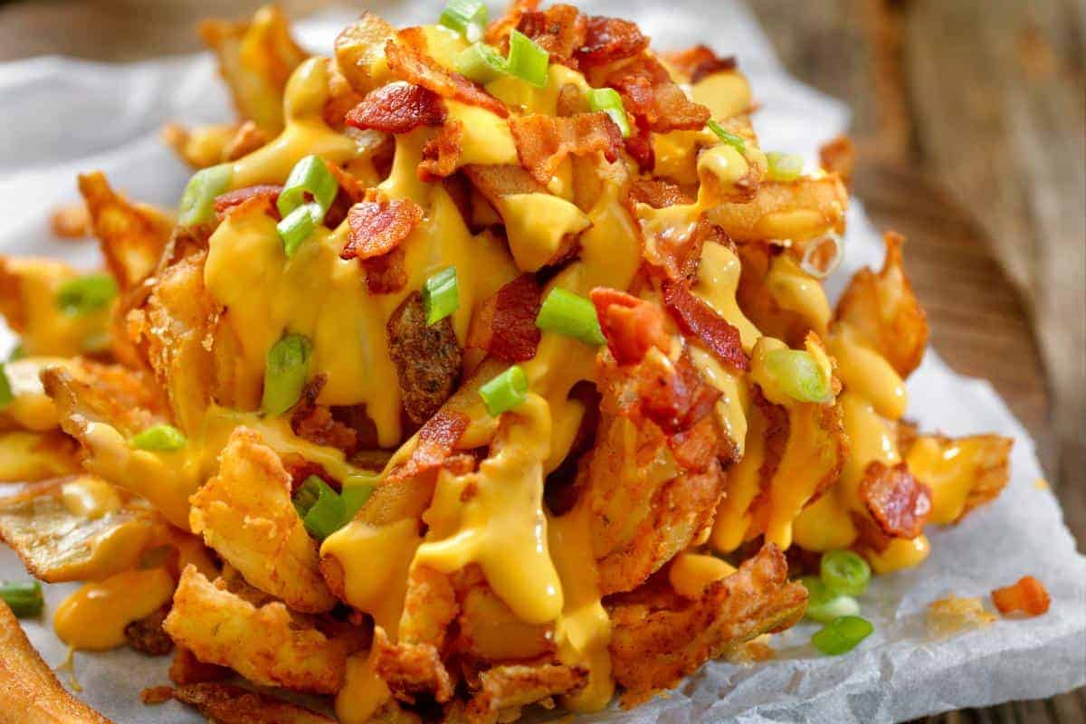 Slimming World loaded fries topped with cheese and bacon.