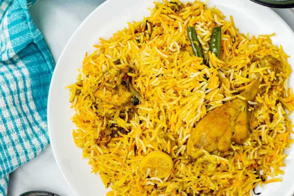 Chicken biryani showing yellow rice with chunks of chicken mixed through.