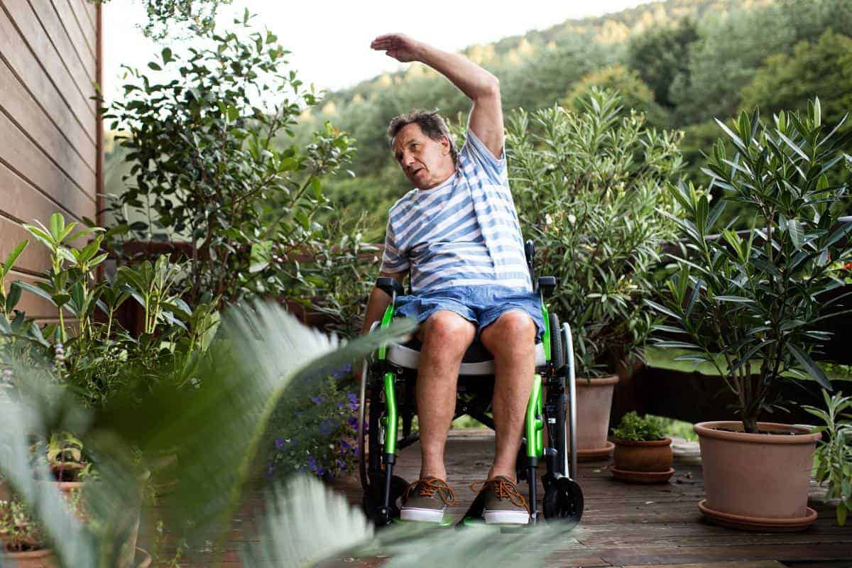 man in a wheelchair doing exercises