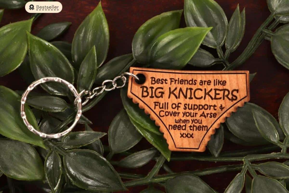 A wooden knicker shape keyring with the words \"best friends are like big knickers full of support and cover your arse when you need them\".