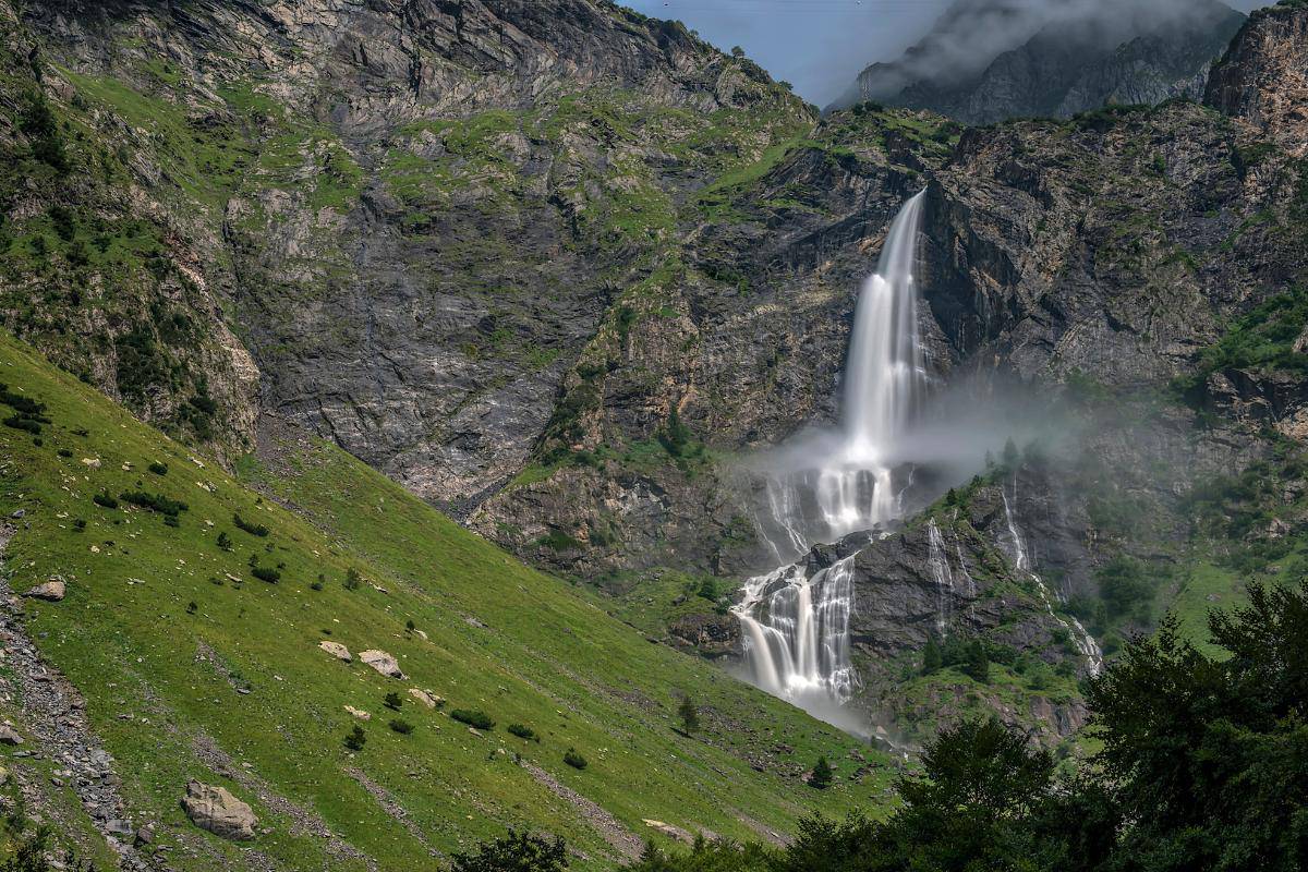 Italian waterfall with water splashing down the mountain side.