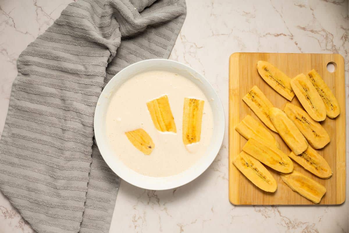 dipping plantain in batter mix.