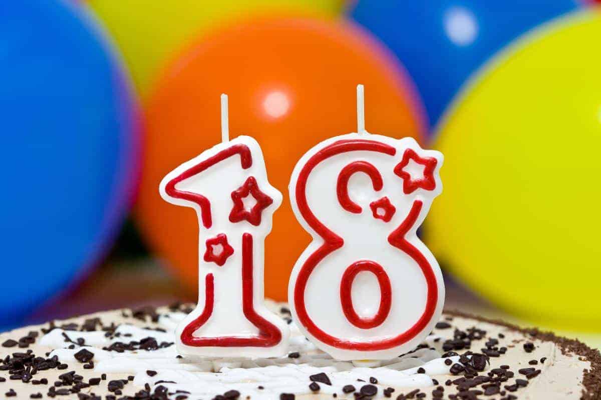 A cake with a 1 candle and an 8 candle on for an 18th birthday