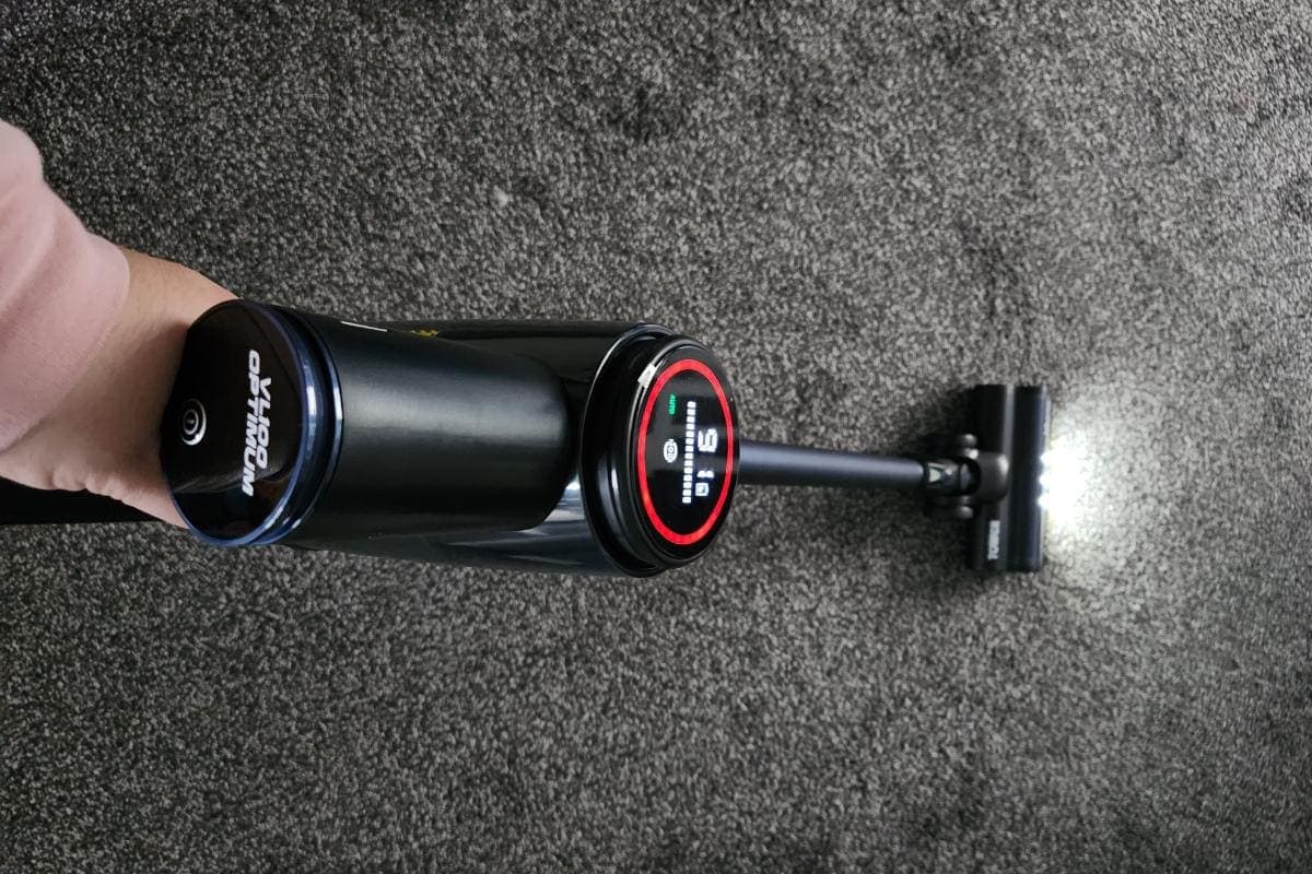 a hand holding a vacuum cleaner