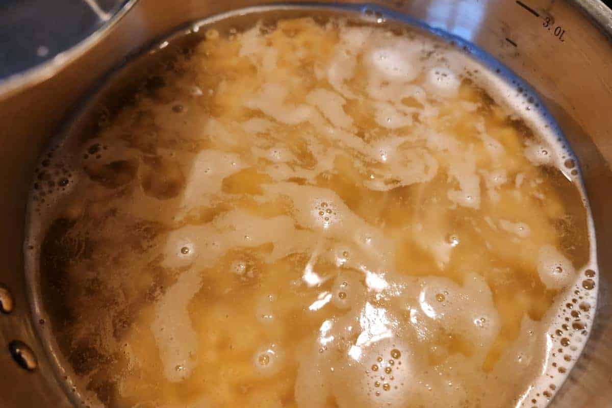 Past being boiled in a saucepan.