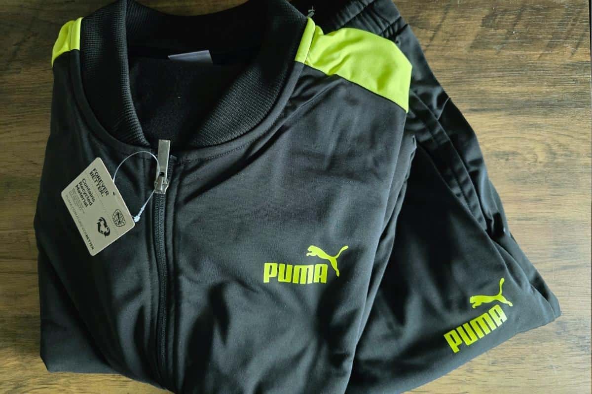 Puma black tracksuit with bright yellow logo and strip to the arm.