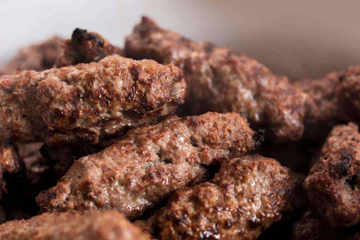 Close-up of several grilled Healthy Beef Kebabs, with a browned and slightly charred exterior, piled together—a delicious option for a healthy dinner.