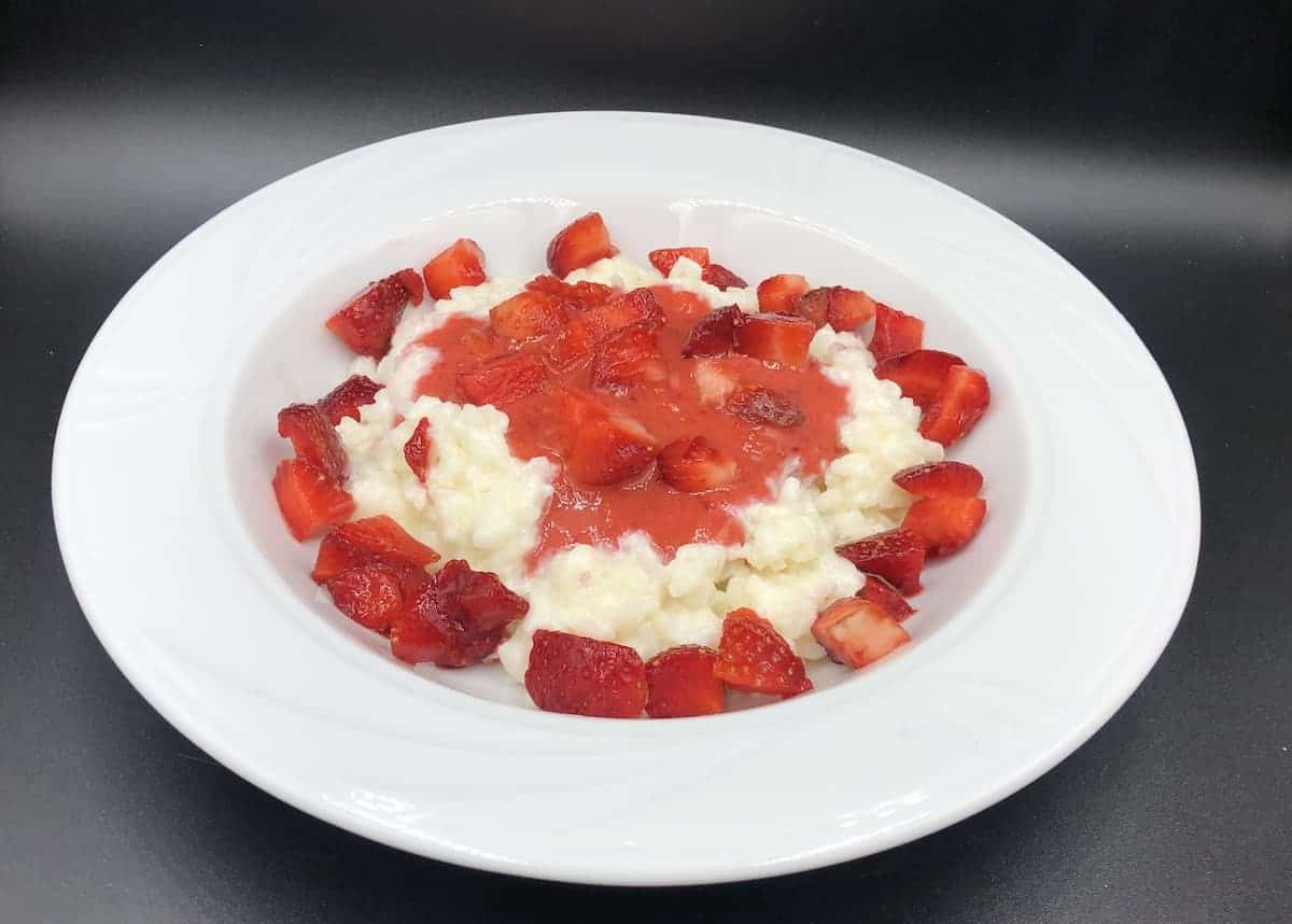 Polish Rice Pudding With Strawberries Recipe in a white bowl.