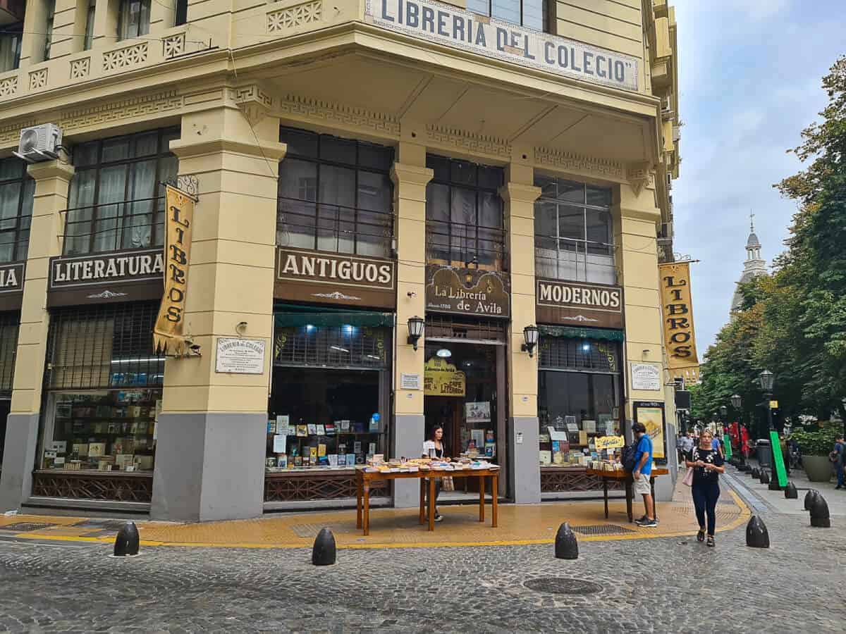 La Librería de Ávila, the oldest bookstore in Buenos Aires, showcasing its historic facade, vintage signage, and a selection of antique and modern books on display outside, a hidden gem in San Telmo neughborhood.