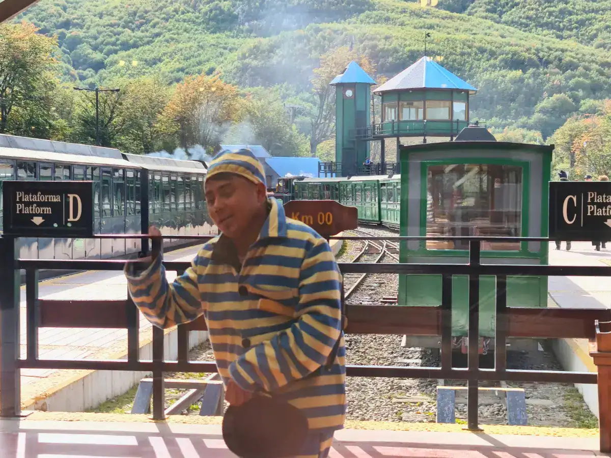 Guide dressed in striped prisoner costume at the End of the World Train station in Ushuaia, symbolizing the history of Tierra del Fuego prison