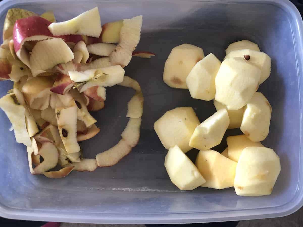 Cored and peeled apples in a tray.