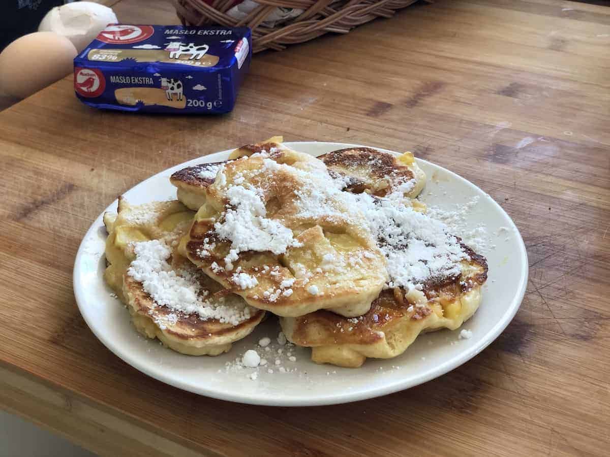 Polish apple pancakes on a white plate.