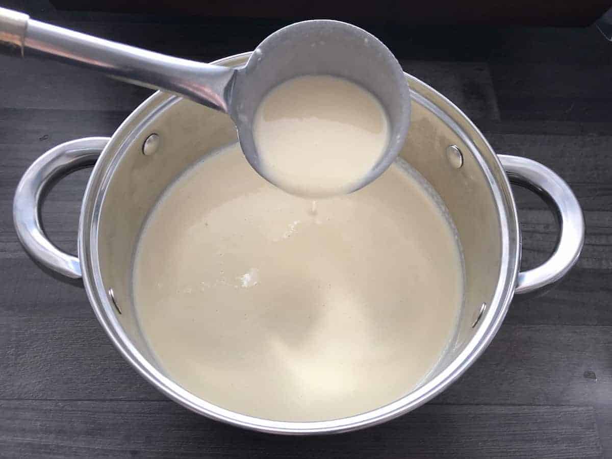 Batter in ladle spoon and pot.