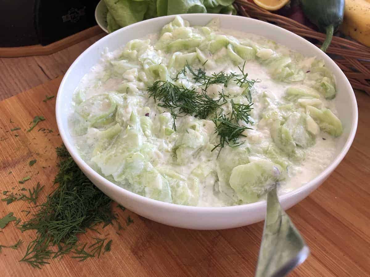 A Polish cucumber salad on a cutting board.