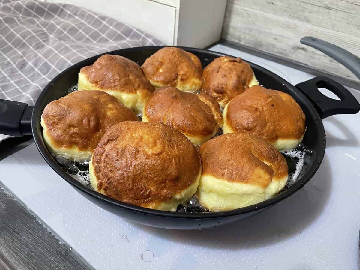 Fry the paczki donuts on both sides.