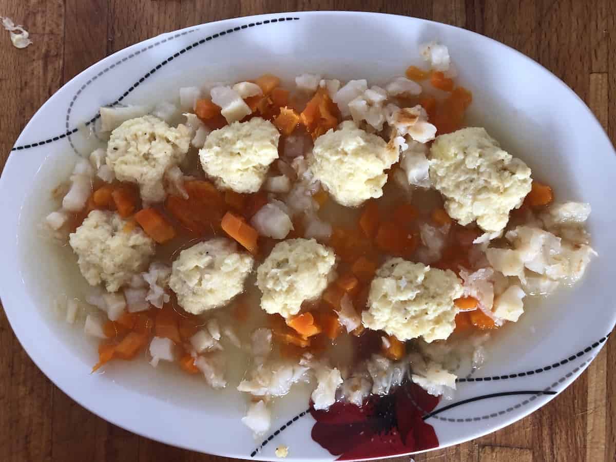 Chopped veggies and fish balls in a white platter.