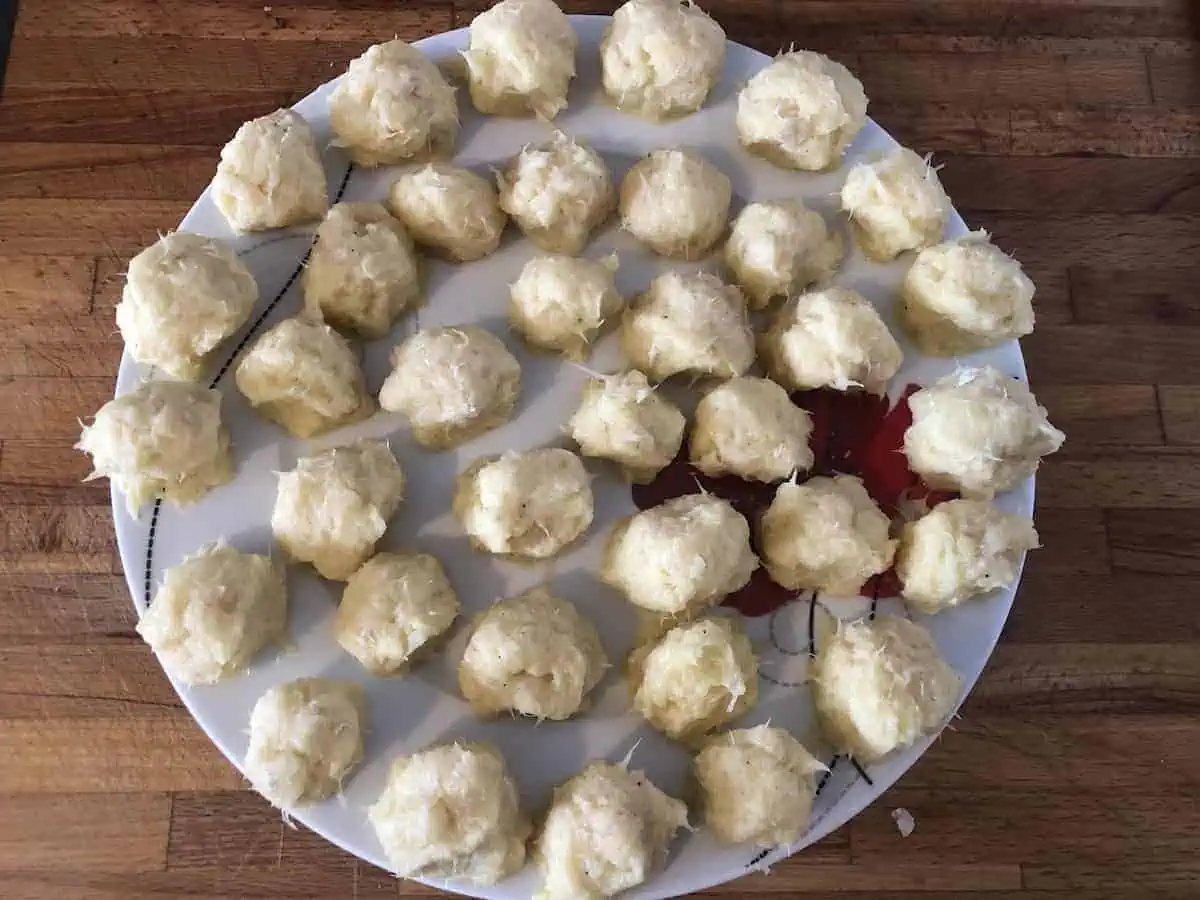 Small balls of fish and egg on a white plate.