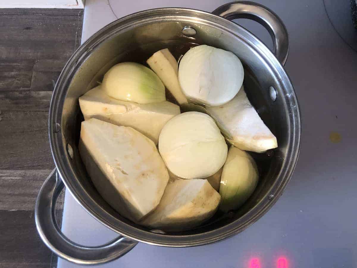 Veggies boiling in a steel pot.