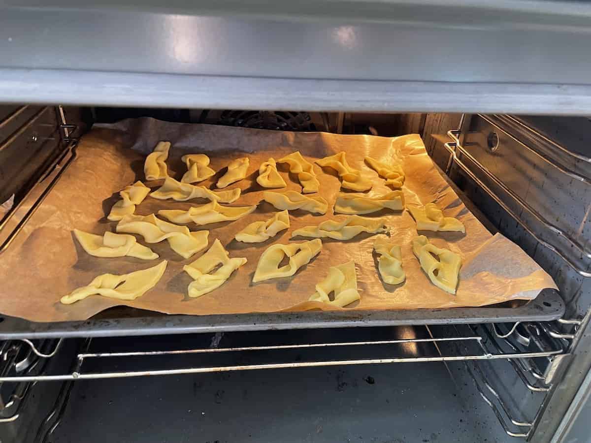 Chrullers baking in a oven.