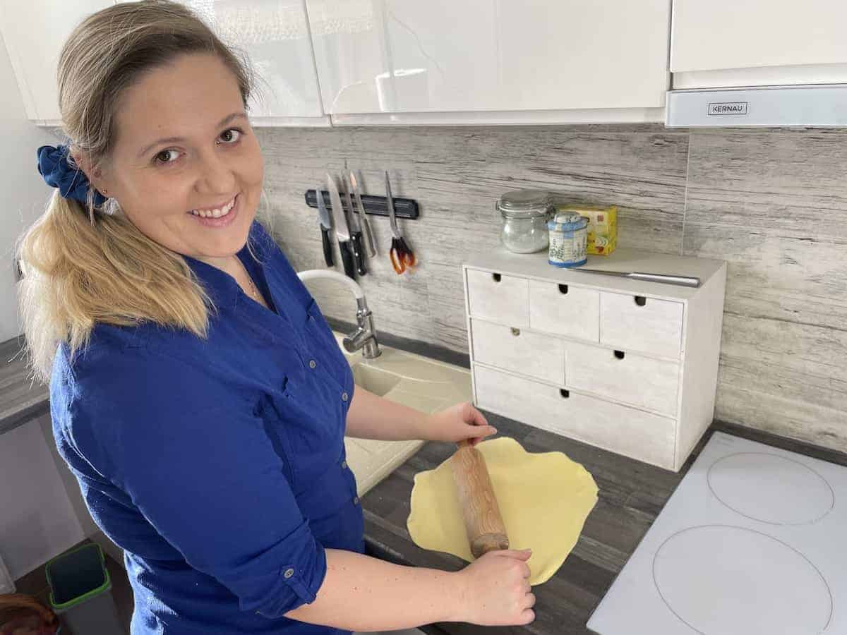 Woman rolling dough.