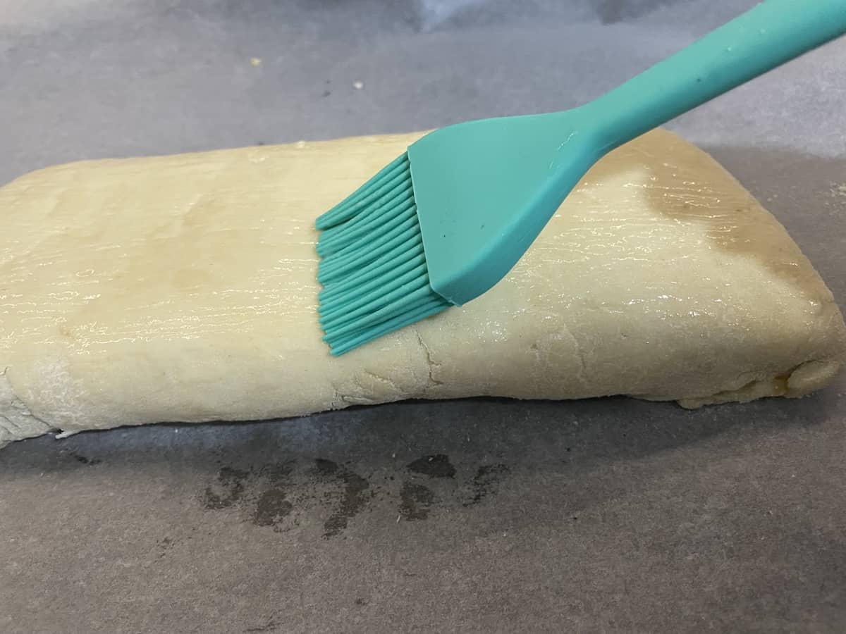 Brush the Easter bread with egg white.