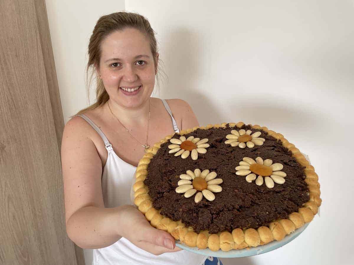 Lady (Karolina) holding a poppy seed mazurek.