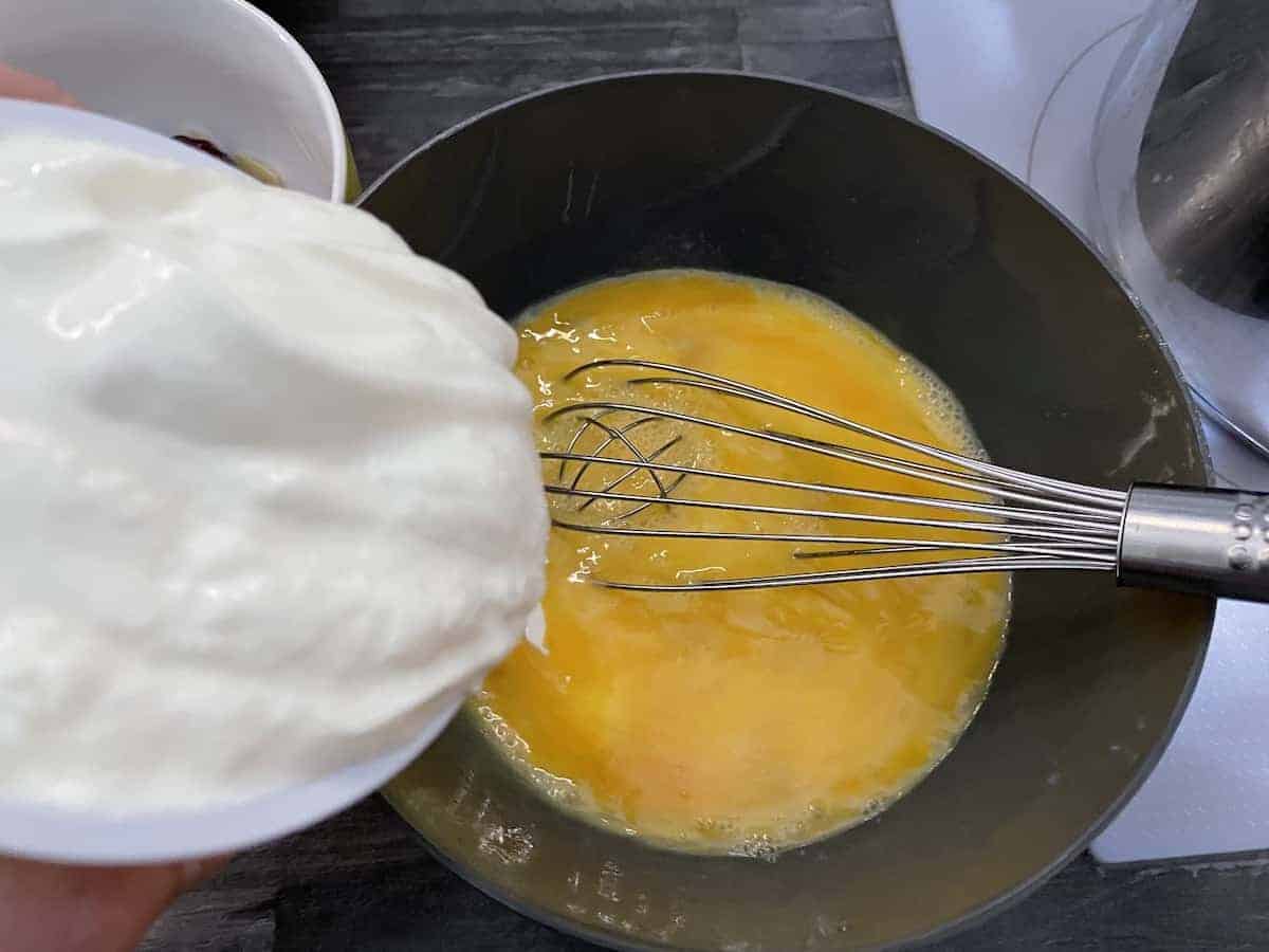 Whisk eggs and add sour cream.