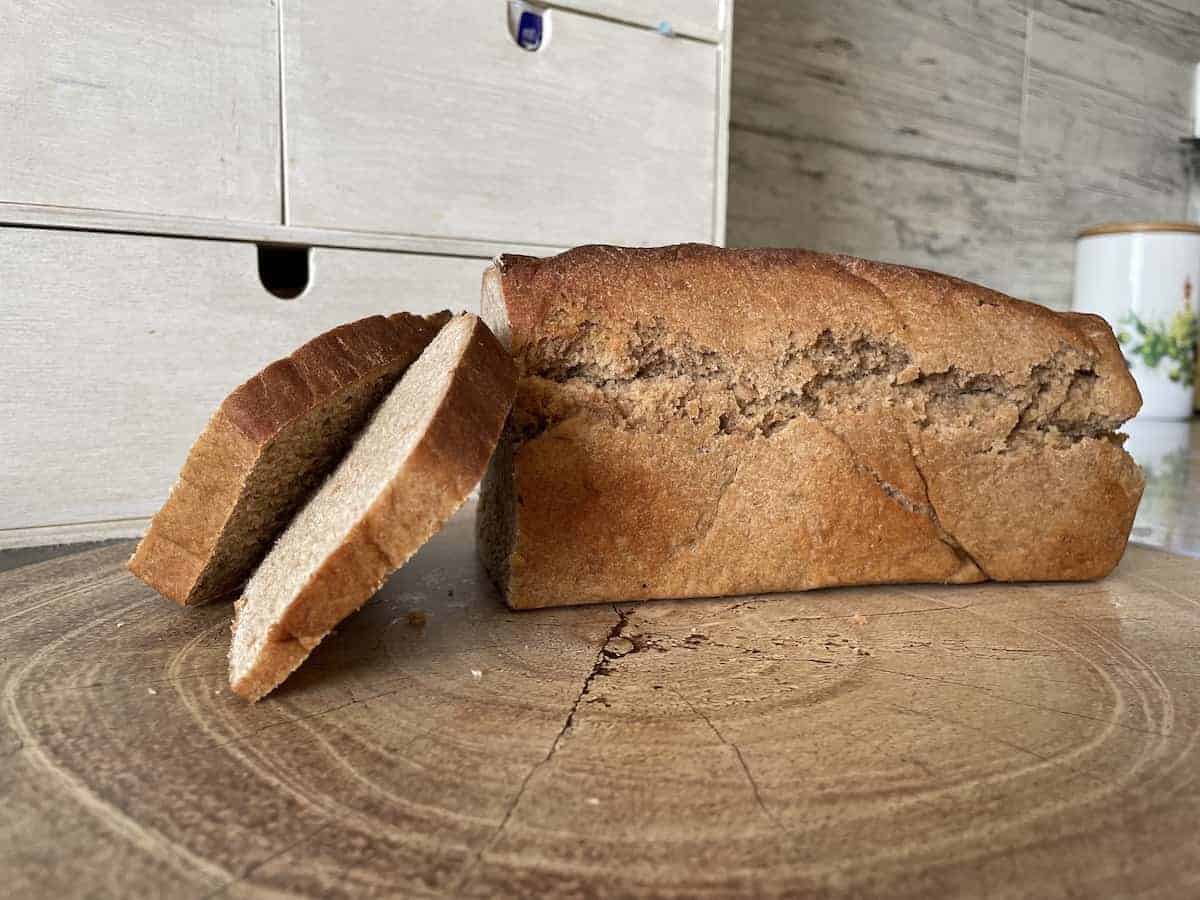 Homemade Polish spelt bread on a wooden chopping board.