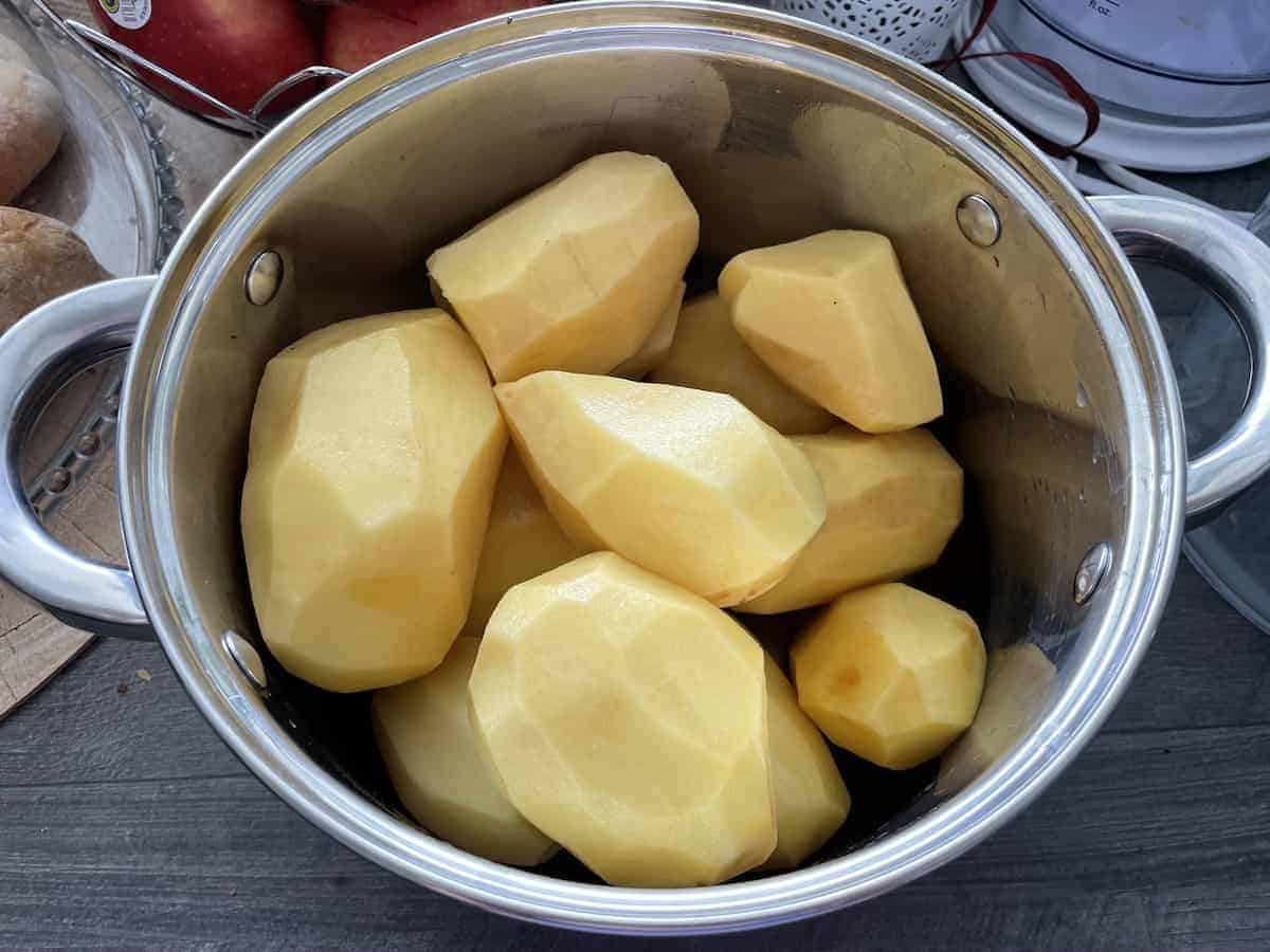 Peeled potatoes in a pot.