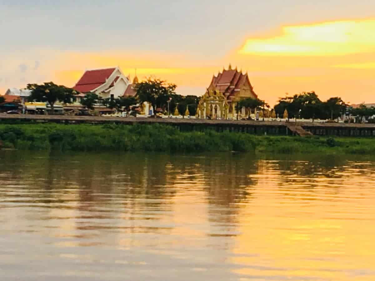 Sunset over the river in Nakhon Phanom on our 3-day itinerary.