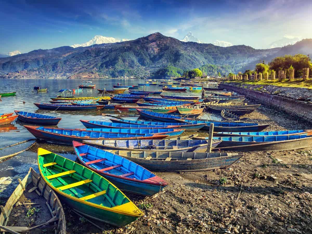 Things to Do in Pokhara Nepal Things to Do in Pokhara Nepal. Colourful wooden boats at the edge of of Pokhara lake with mountains in the background.