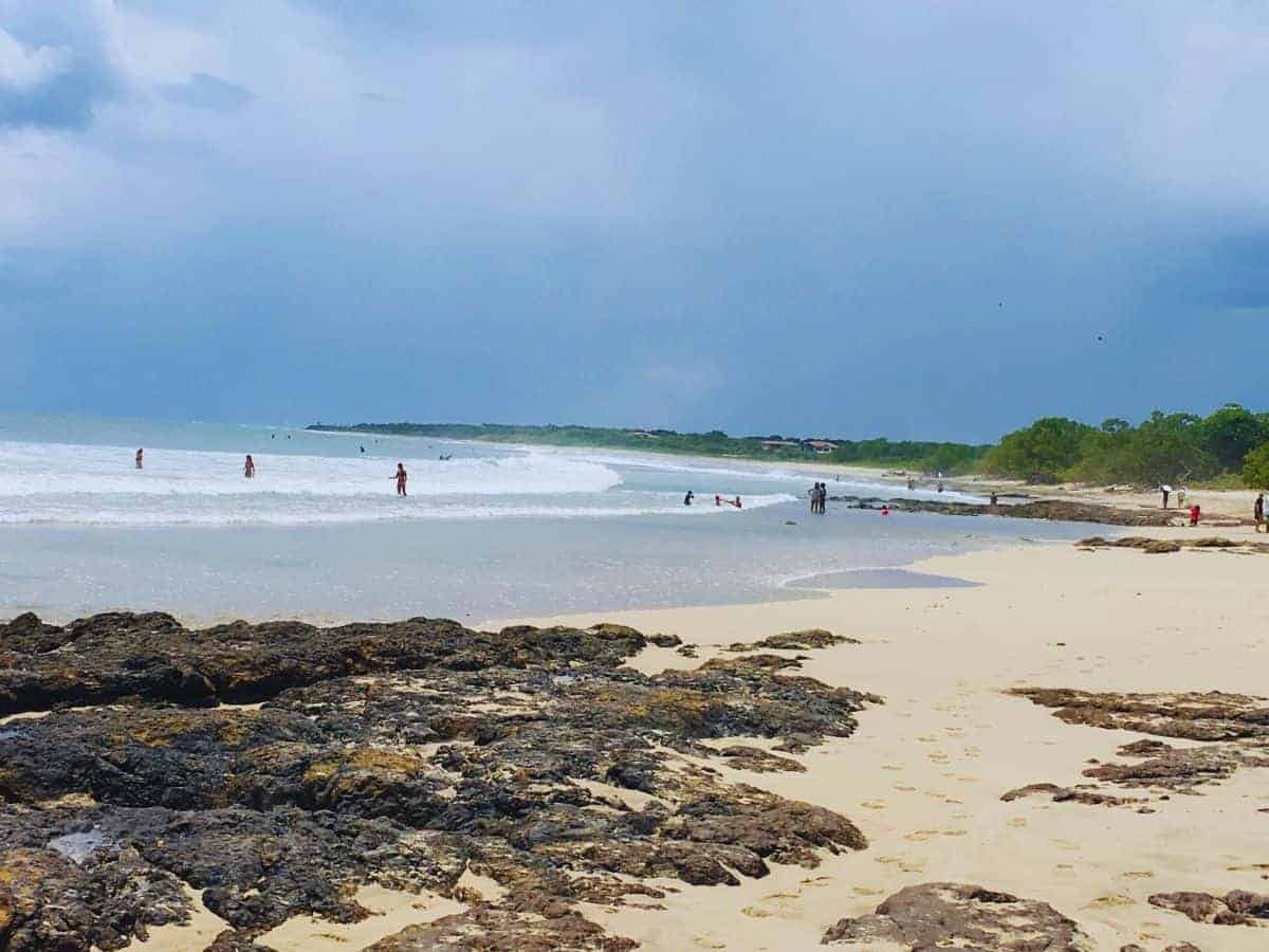 Things to Do in Playa Avellanas in Costa Rica Things to Do in Playa Avellanas in Costa Rica - yellow sand beach with rocks in the left foreground and sea and sky in the background