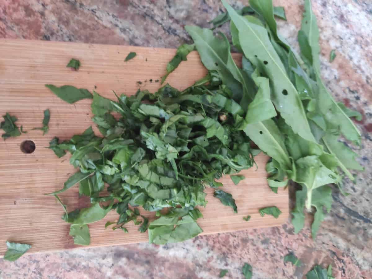 Chopped sorrel leaves on a cutting board.