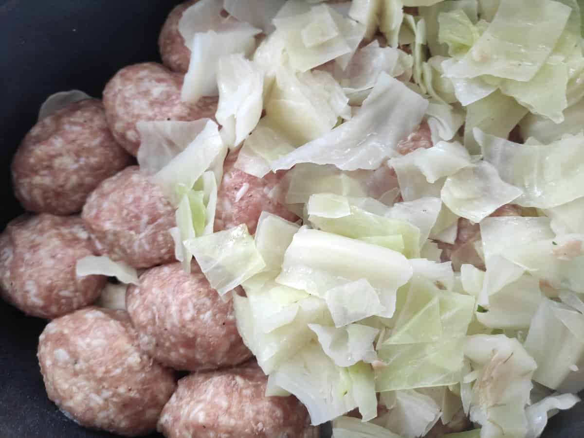 Cover the meatballs with more cabbage.