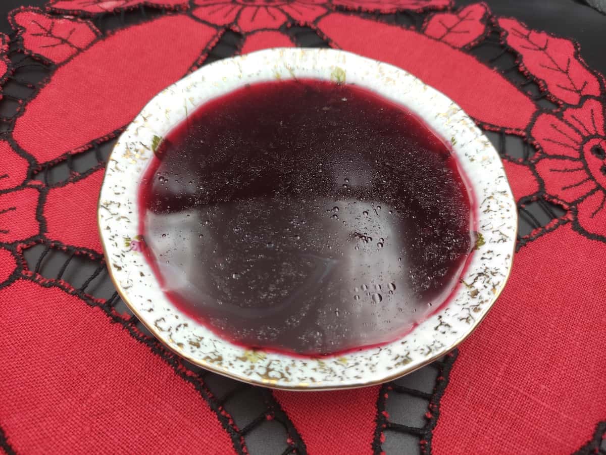 Beetroot sourdough starter in a white bowl.