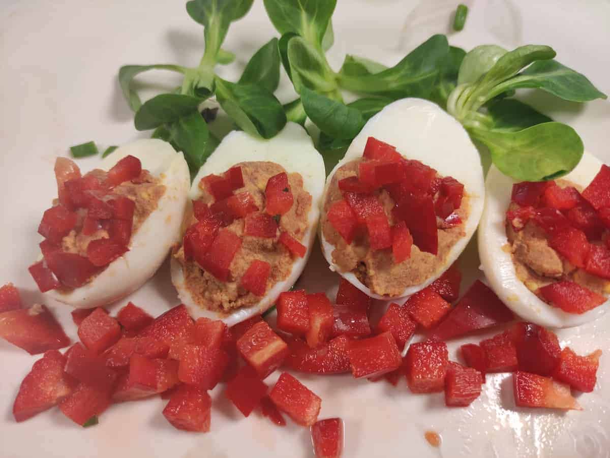 Deviled eggs with chopped bell peppers.