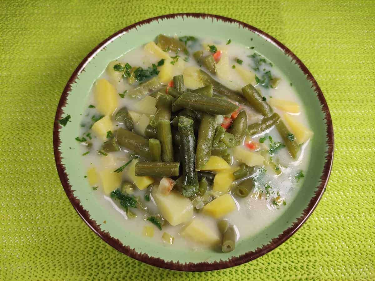 Polish green bean soup in a bowl.