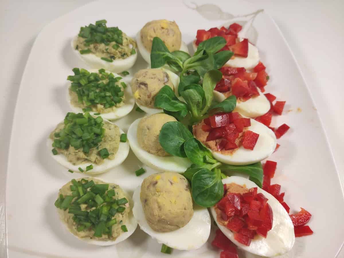 Polish deviled eggs called jajka faszerowane on a white platter.