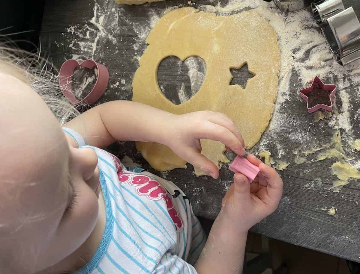 Child cutting cookie shapes.