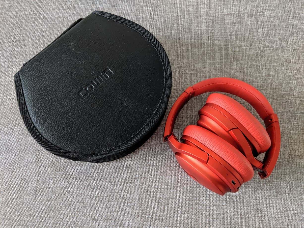 Red se7 folded headphones and case on grey surface