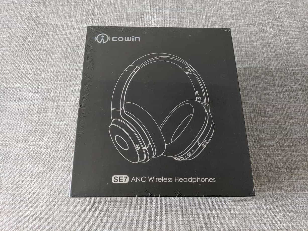 Cowin se7 headphones in packaging on grey surface