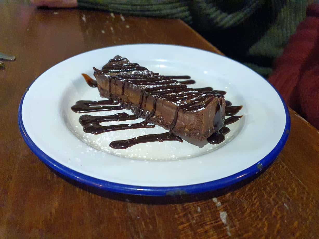 Chocolate torte with chocolate sauce on white plate at the Horn in Hand, Nottingham